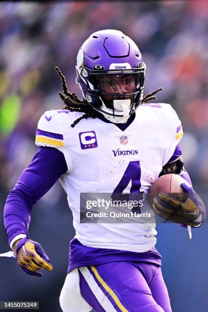 Running back Dalvin Cook of the Minnesota Vikings carries the ball during the game against the Chicago Bears at Soldier Field on January 08, 2023 in...