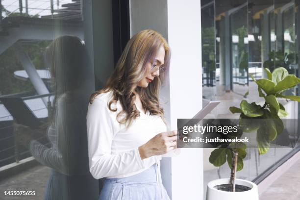 standing thai transgender with digital tablet - kathoey stock pictures, royalty-free photos & images