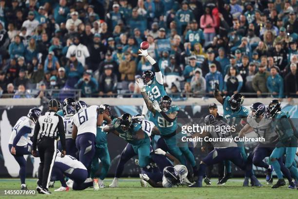 Arden Key of the Jacksonville Jaguars attempts to block a kick by Randy Bullock of the Tennessee Titans during the first half at TIAA Bank Field on...