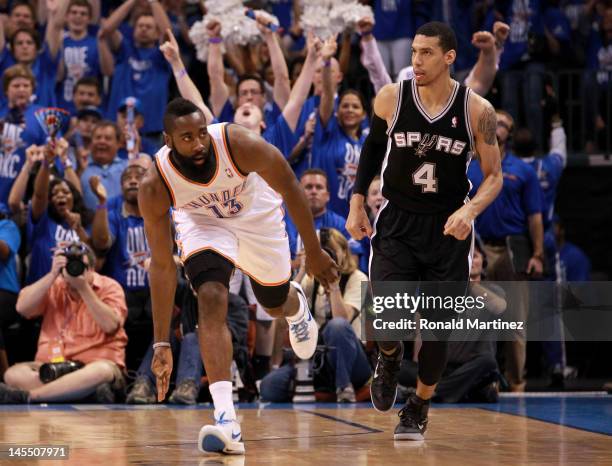 James Harden of the Oklahoma City Thunder reacts after making a three-pointer alongside Danny Green of the San Antonio Spurs in the first half in...