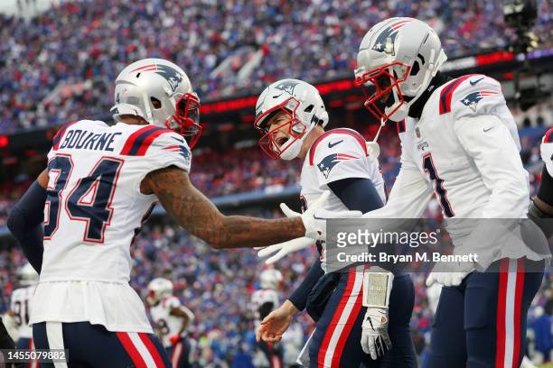 Kendrick Bourne of the New England Patriots and Mac Jones of the New England Patriots celebrate with DeVante Parker of the New England Patriots after...