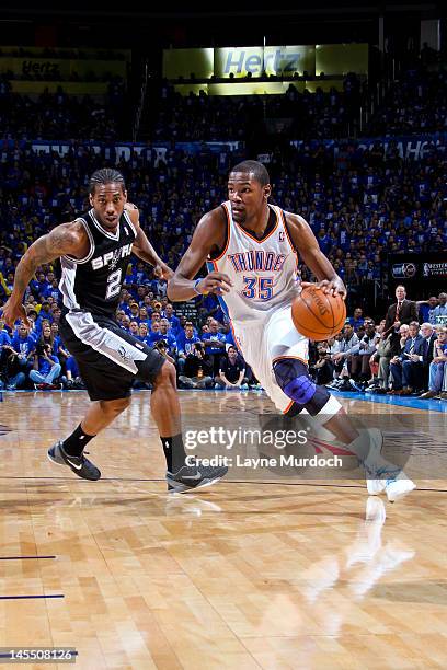 Kevin Durant of the Oklahoma City Thunder drives against Kawhi Leonard of the San Antonio Spurs in Game Three of the Western Conference Finals during...