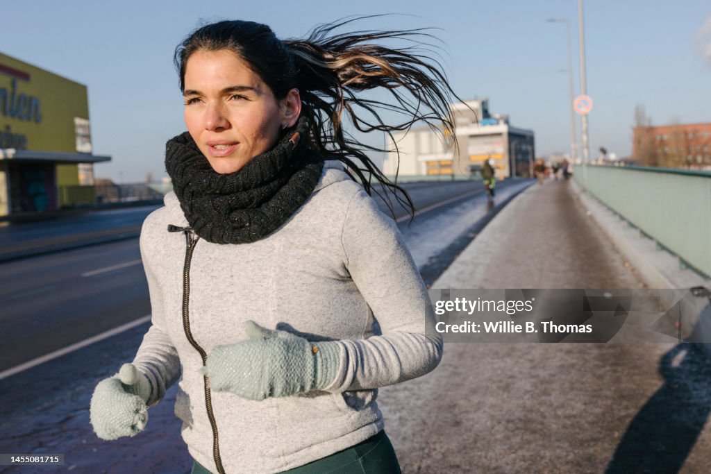 One woman running on a chilly day