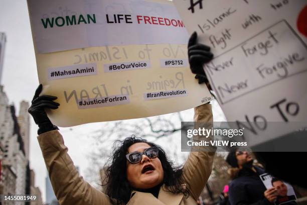 Woman holds a placard as people take part in a march on January 8, 2023 in New York. People from Woman Life Freedom NYC and local Iranian activists...