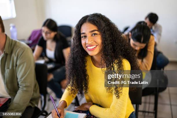 portrait of a young woman studying in the classroom at university - tredjeårselev bildbanksfoton och bilder