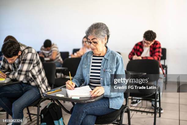 senior woman studying in the classroom at university - onderwijsinstituten en organisaties stockfoto's en -beelden