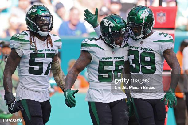 Quincy Williams of the New York Jets celebrates with Will Parks of the New York Jets after breaking up a pass during the third quarter against the...