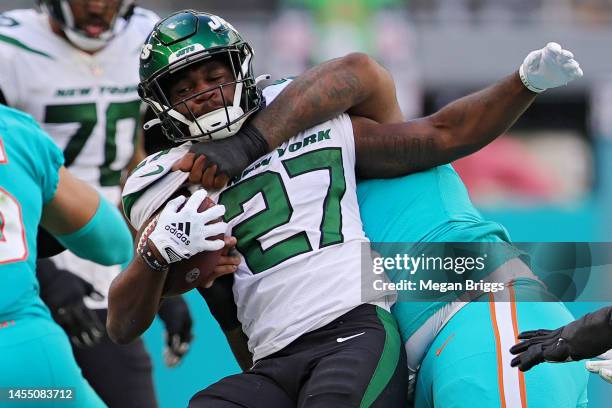 John Jenkins of the Miami Dolphins tackles Zonovan Knight of the New York Jets during the third quarter at Hard Rock Stadium on January 08, 2023 in...