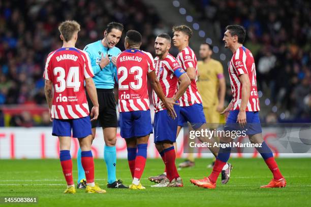 Referee Jose Luis Munuera Montero speaks to Reinildo Mandava of Atletico Madrid during the LaLiga Santander match between Atletico de Madrid and FC...