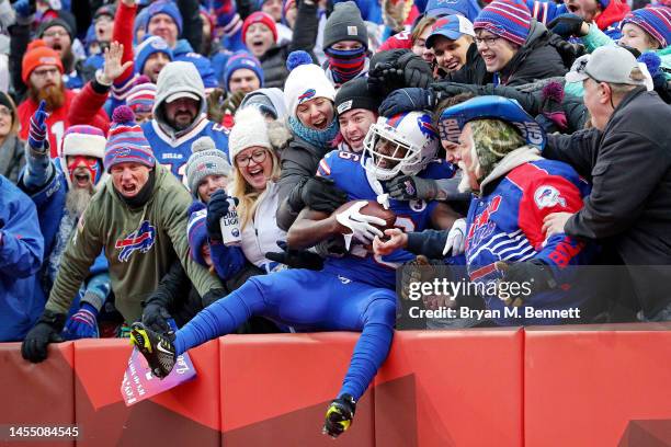 John Brown of the Buffalo Bills celebrates with fans after catching a touchdown pass during the third quarter against the New England Patriots at...