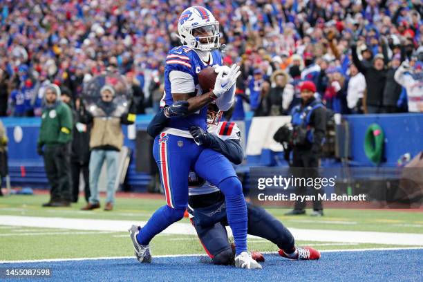 Stefon Diggs of the Buffalo Bills scores a touchdown while Jonathan Jones of the New England Patriots attempts to tackle him during the fourth...