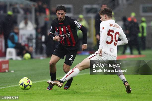 Davide Calabria of AC Milan is challenged by Nicola Zalewski of AS Roma during the Serie A match between AC Milan and AS Roma at Stadio Giuseppe...