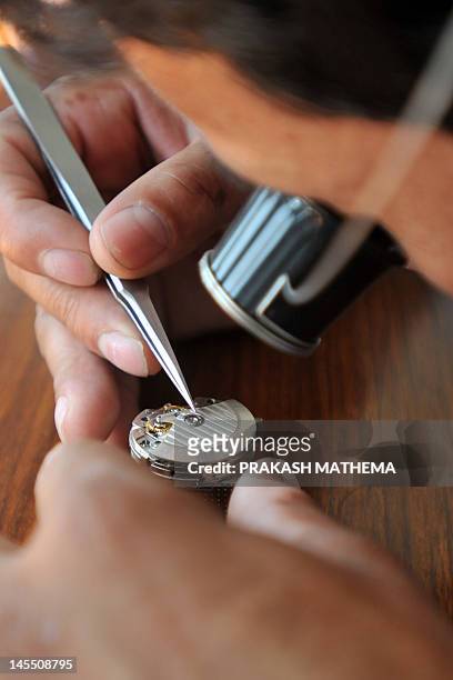 To go with story 'Lifestyle-Nepal-US-fashion-Everest' by Frankie Taggart Nepalese watchmaker Lakpa Thundu Sherpa works on a timepiece at the Kobold...