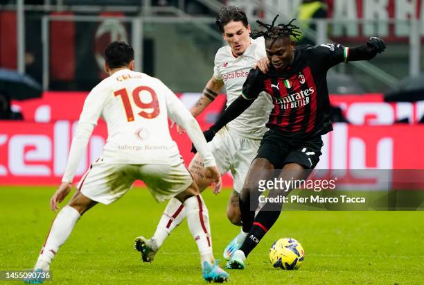 Rafael Leão of AC Milan is tackled by Nicolò Zaniolo of AS Roma during the Serie A match between AC MIlan and AS Roma at Stadio Giuseppe Meazza on...