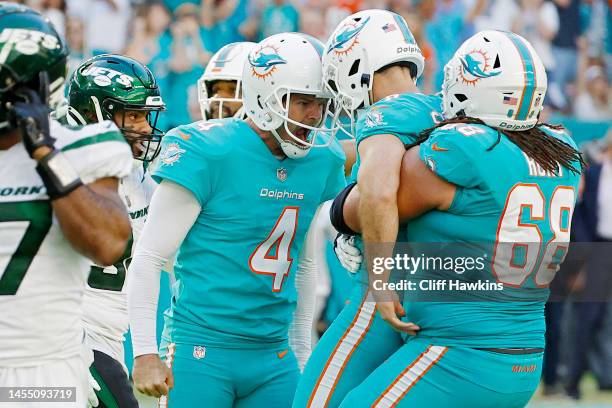 Thomas Morstead of the Miami Dolphins and Robert Hunt of the Miami Dolphins celebrate with Jason Sanders of the Miami Dolphins after Sanders game...
