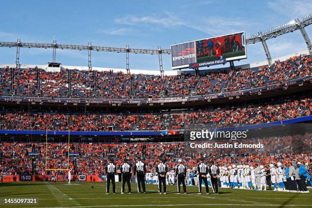 Officials stand on the field prior to a game between the Denver Broncos and the Los Angeles Chargers at Empower Field At Mile High on January 08,...