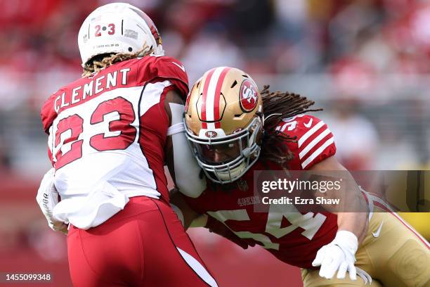 Fred Warner of the San Francisco 49ers tackles Corey Clement of the Arizona Cardinals during the first half at Levi's Stadium on January 08, 2023 in...