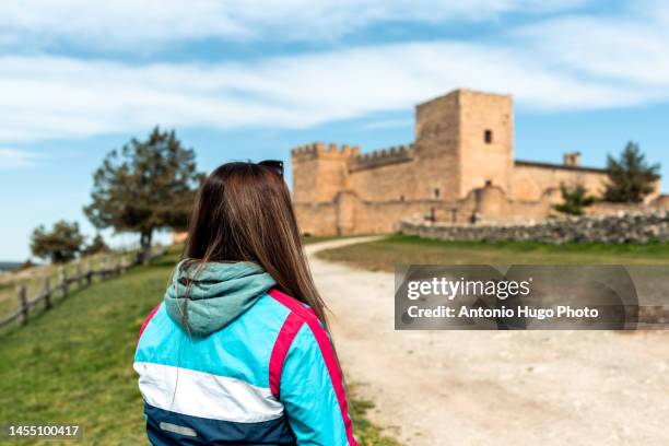 rear view of a young blonde woman in the castle of pedraza, segovia. - castilla y leon stock pictures, royalty-free photos & images