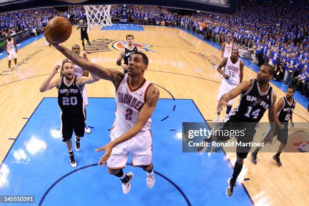 Thabo Sefolosha of the Oklahoma City Thunder lays the ball up against Gary Neal of the San Antonio Spurs in Game Three of the Western Conference...