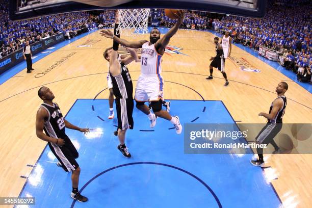 James Harden of the Oklahoma City Thunder goes up for a shot against Tiago Splitter of the San Antonio Spurs in Game Three of the Western Conference...