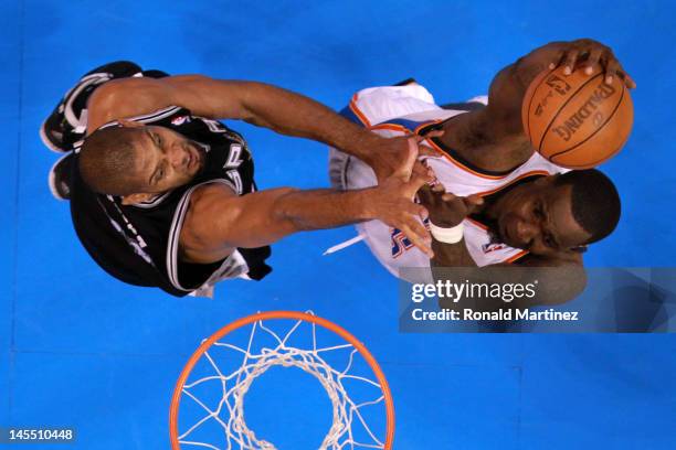 Kendrick Perkins of the Oklahoma City Thunder goes up for a dunk over Tim Duncan of the San Antonio Spurs in Game Three of the Western Conference...