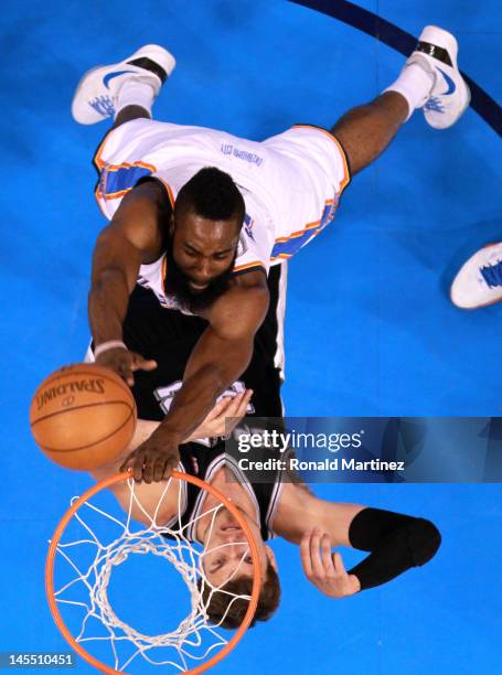 James Harden of the Oklahoma City Thunder goes up for a shot over Tiago Splitter of the San Antonio Spurs in Game Three of the Western Conference...