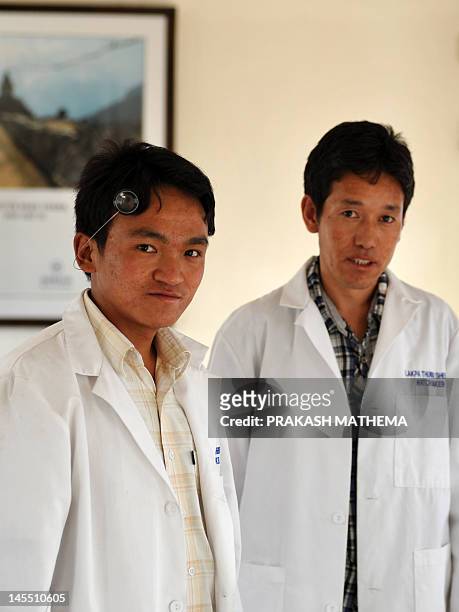 Nepalese watchmakers Ang Namgel Sherpa and Lakpa Thundu Sherpa pose at the Kobold watch workshop in Kathmandu on April 25, 2012. In a modern, airy...