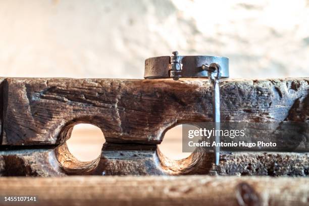 wooden stocks and shackles. medieval torture instruments. - medieval torture devices photos et images de collection