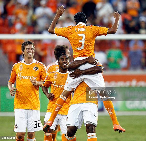 Calen Carr of the Houston Dynamo celebrates with Corey Ashe, Bobby Boswell, Adam Moffat and Jermaine Taylor after scoring against Valencia in the...