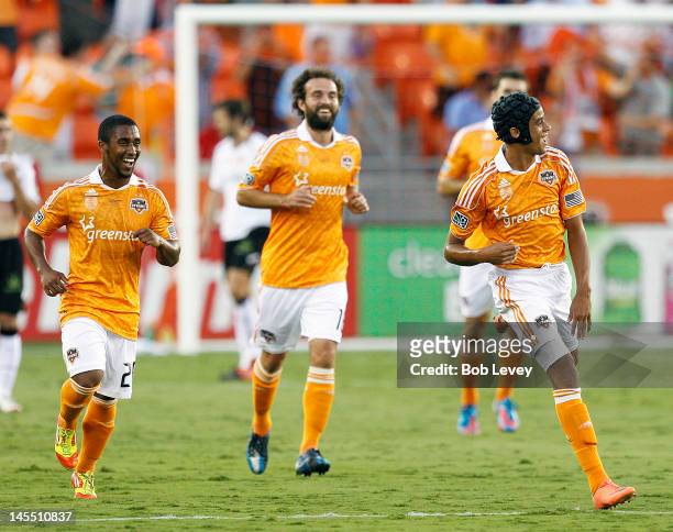 Calen Carr of the Houston Dynamo celebrates with Corey Ashe and Adam Moffat after scoring against Valencia in the first half at BBVA Compass Stadium...