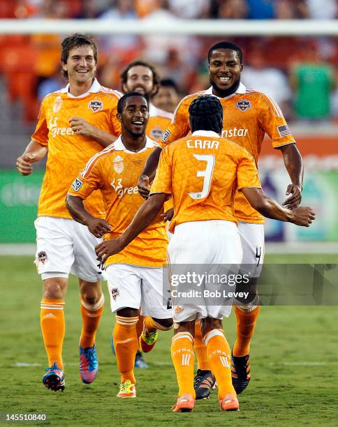 Calen Carr of the Houston Dynamo celebrates with Corey Ashe, Bobby Boswell, Adam Moffat and Jermaine Taylor after scoring against Valencia in the...