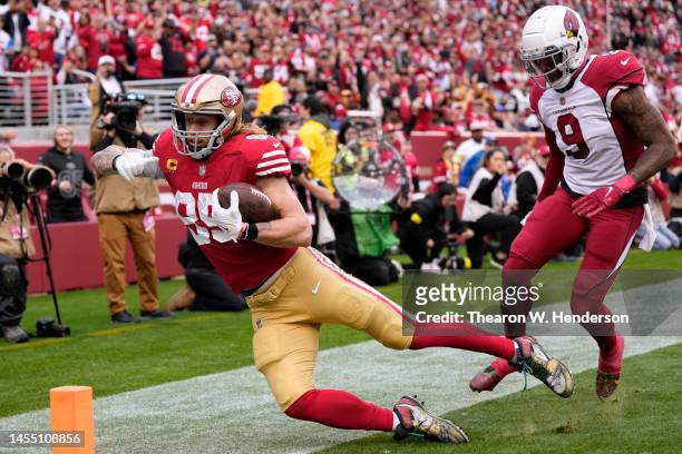 Charlie Woerner of the San Francisco 49ers catches a pass in front of Isaiah Simmons of the Arizona Cardinals for a touchdown during the second...