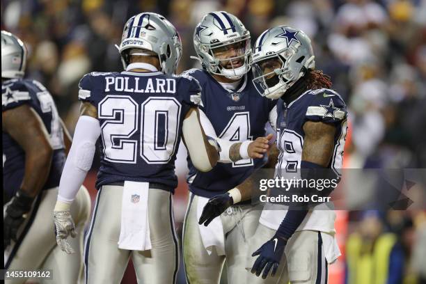 Dak Prescott of the Dallas Cowboys celebrates a successful play with CeeDee Lamb of the Dallas Cowboys during the second quarter of the game against...