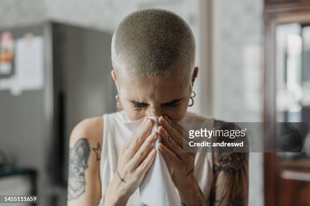 woman with cold sinusitis sneezing - sinusitis stock pictures, royalty-free photos & images