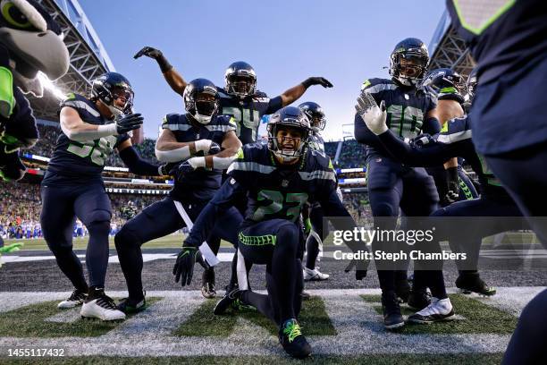 The Seattle Seahawks celebrate an interception by Quandre Diggs against the Los Angeles Rams during overtime at Lumen Field on January 08, 2023 in...