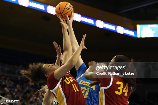Destiny Littleton of the USC Trojans, Lina Sontag of the UCLA Bruins, and Clarice Akunwafo of the USC Trojans reach for a rebound during the second...