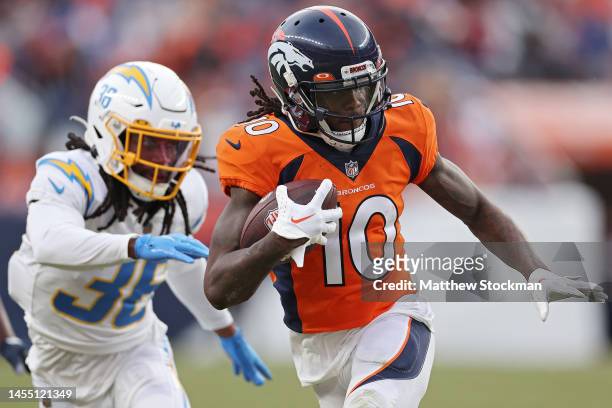 Jerry Jeudy of the Denver Broncos runs past Ja'Sir Taylor of the Los Angeles Chargers during the third quarter at Empower Field At Mile High on...