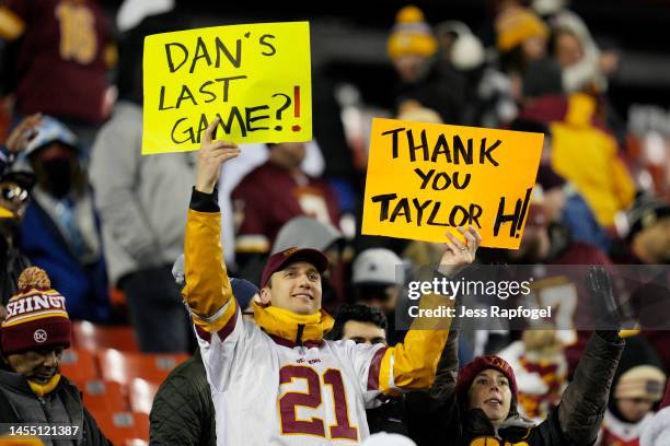 Fan holds up signs during the game between the Dallas Cowboys and Washington Commanders at FedExField on January 08, 2023 in Landover, Maryland.