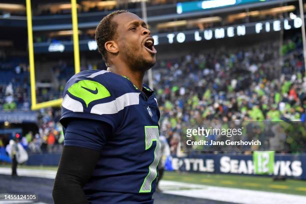 Geno Smith of the Seattle Seahawks celebrates after defeating the Los Angeles Rams in overtime at Lumen Field on January 08, 2023 in Seattle,...