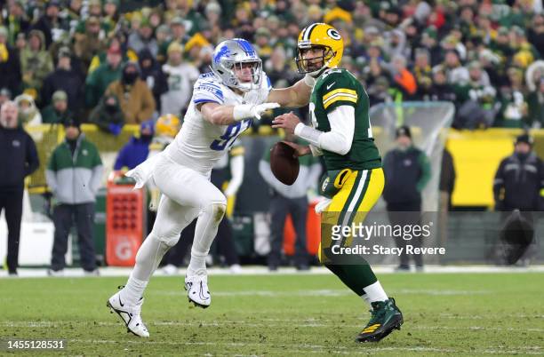 Aidan Hutchinson of the Detroit Lions sacks Aaron Rodgers of the Green Bay Packers during the first quarter at Lambeau Field on January 08, 2023 in...