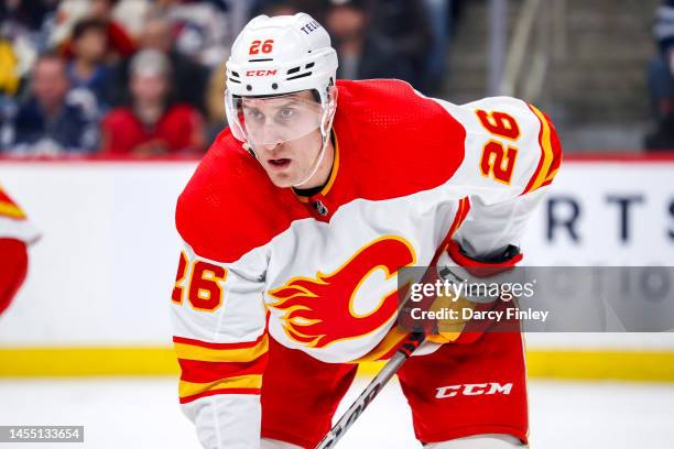 Michael Stone of the Calgary Flames gets set during a first period face-off against the Winnipeg Jets at the Canada Life Centre on January 3, 2023 in...