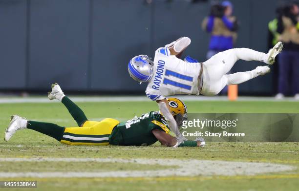 Kalif Raymond of the Detroit Lions is tackled by Adrian Amos of the Green Bay Packers during the second quarter at Lambeau Field on January 08, 2023...