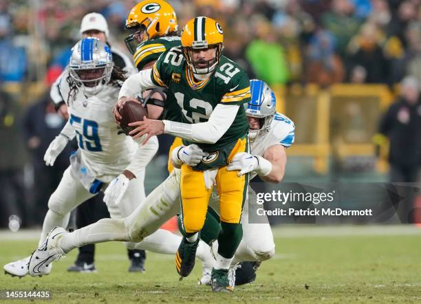 Aidan Hutchinson of the Detroit Lions sacks Aaron Rodgers of the Green Bay Packers during the first half at Lambeau Field on January 08, 2023 in...