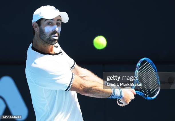 Jordan Thompson of Australia hits a backhand against Michael Ymer of Sweden during day one of the 2023 Adelaide International at Memorial Drive on...