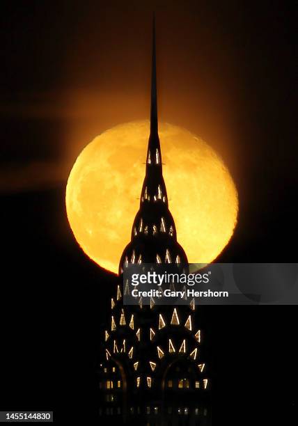 Percent waning gibbous moon rises behind the Chrysler Building in New York City on January 8 as seen from Jersey City, New Jersey.