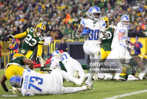 Jamaal Williams of the Detroit Lions rushes for a touchdown during the third quarter against the Green Bay Packers at Lambeau Field on January 08,...