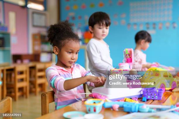 children playing together in playroom - cuarto de jugar fotografías e imágenes de stock