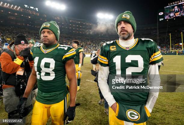 Aaron Rodgers and Randall Cobb of the Green Bay Packers walk off the field after losing to the Detroit Lions at Lambeau Field on January 08, 2023 in...