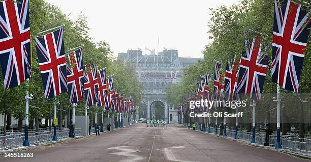 Police horses on The Mall bedecked with Union Flags following a dress rehearsal of the royal carriage procession from Westminster Hall to Buckingham...