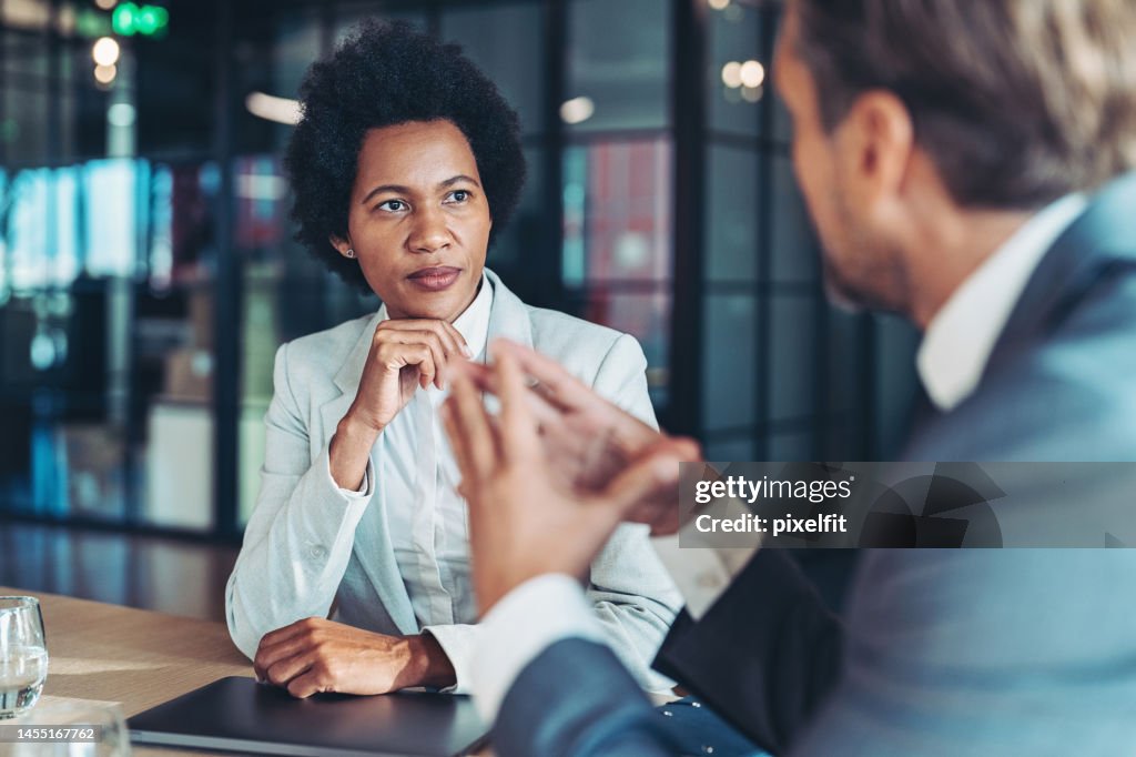 Middle aged businesswoman in a conversation with a colleague